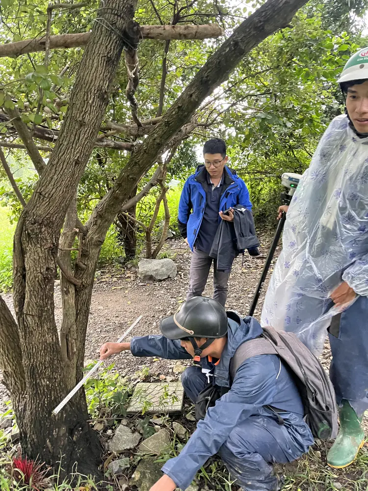 3DSCAN survey team checking a control mark in the field with a GNSS receiver